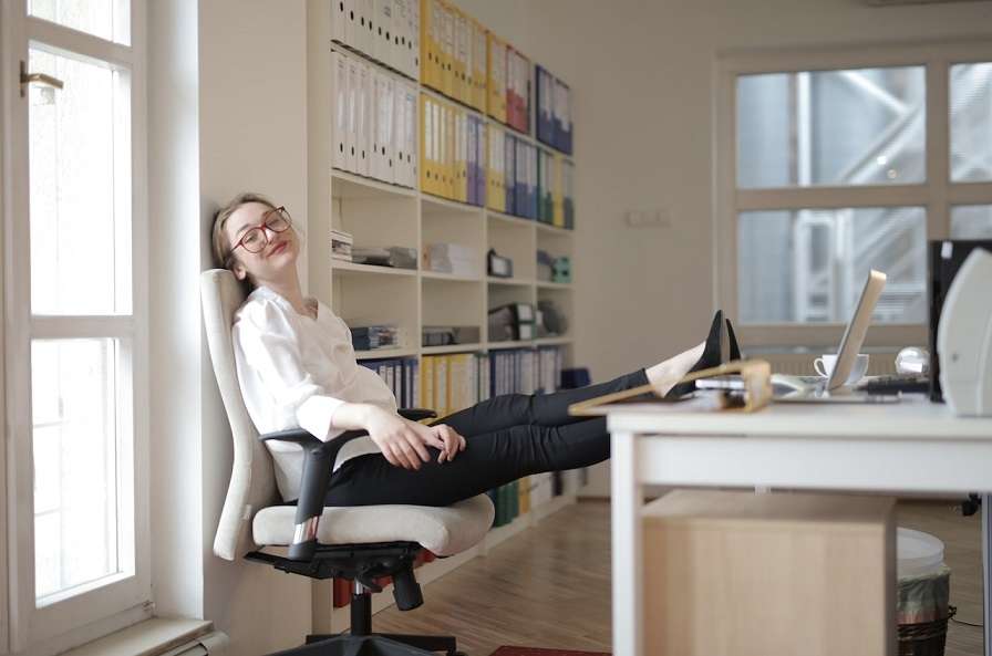 stock image of a girl sitting in her working desk being happy 