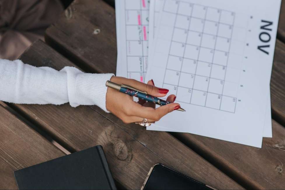 stock image of someone working on a paper calendar 