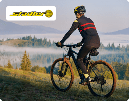 a person running a bike and a logo of stadler