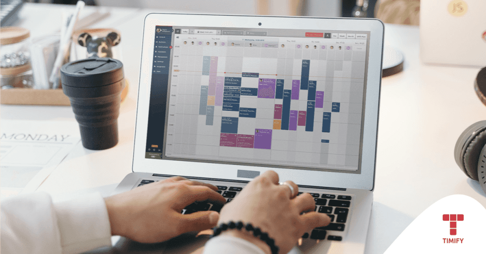 a person working with on a computer on their Timify calendar