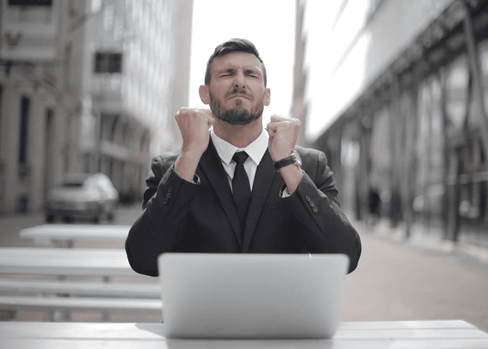 stock image of a man being angry sitting in front of a computer 