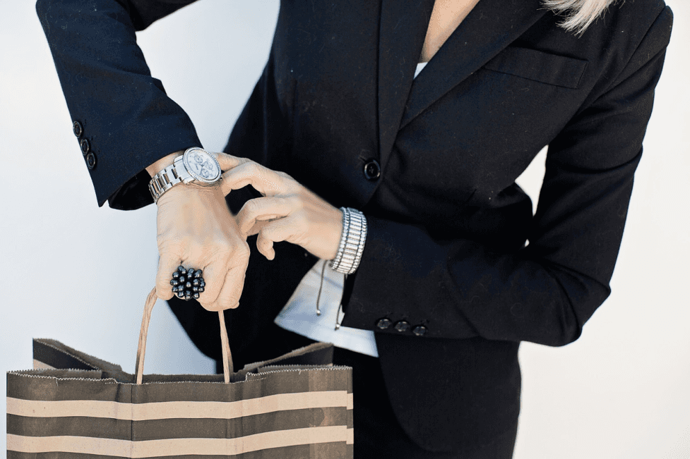 stock image of a busy woman checking her watch 