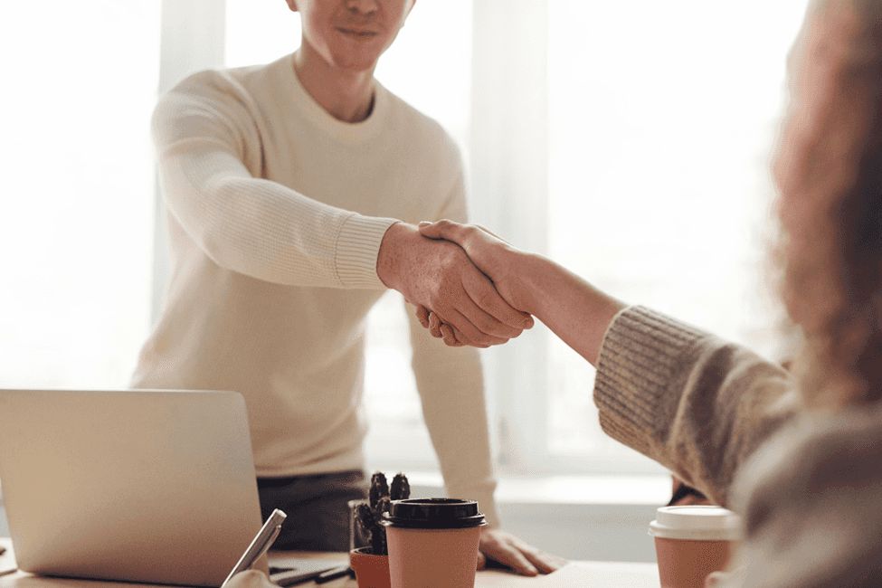 stock image of a person shaking hands with another 