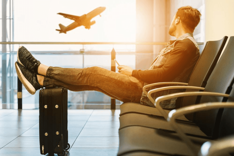 stock image of a man waiting for plane at the airport 