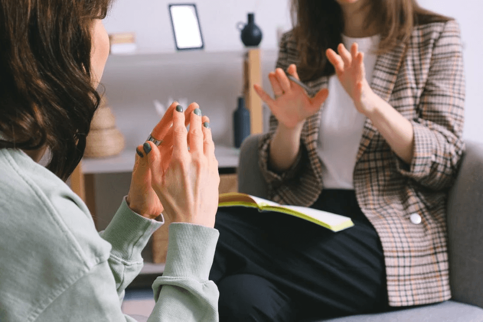 stock image of two women talking together 