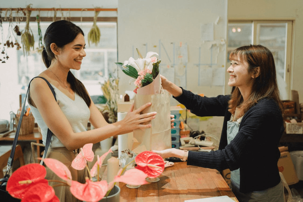 stock image of a woman buying flowers 